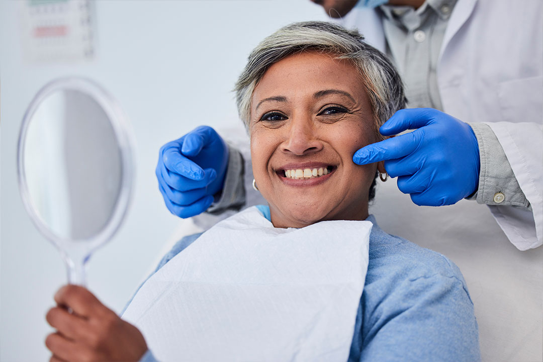 A dentist is adjusting a patient s teeth in a dental office.