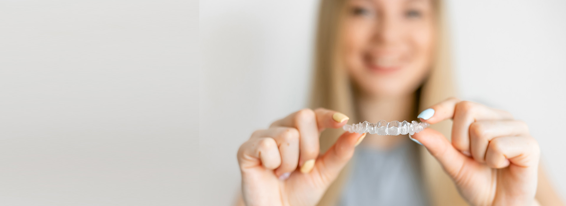 A woman holding a ring with both hands against a blurred background.