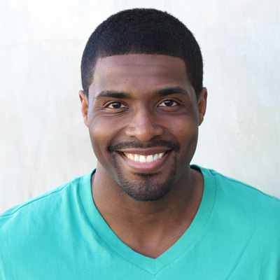 An elderly couple in a relaxed pose, smiling warmly at the camera.
